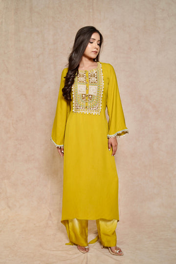 Model wearing a lime green kurta set for women, featuring intricate embroidery and bell sleeves – a perfect festive kurta and palazzo set.