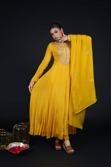 Model gracefully twirling in a Yellow Kalidar Anarkali Suit, showcasing its fluid silhouette and intricate zardozi and gotta patti embroidery.