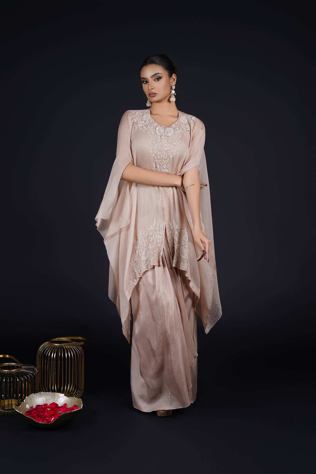 Ash Rose Pink organza cape paired with a drape skirt and crop top, embellished with pearls, sequins, and cutdana embroidery - Perfect for festive and formal events.