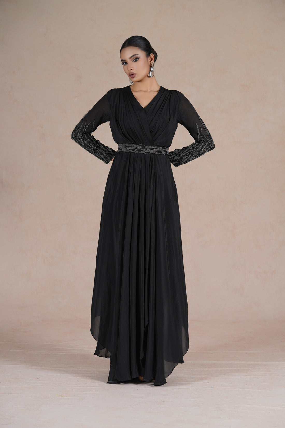 Black Indowestern dress with pearl-embellished belt and full sleeves, featuring a V-neckline and flowing silhouette, perfect for festive and formal occasions.