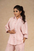 Blush pink textured linen coord set featuring a button-down shirt with puffed sleeves and wide-leg pants, offering a comfortable and stylish look for casual outings.