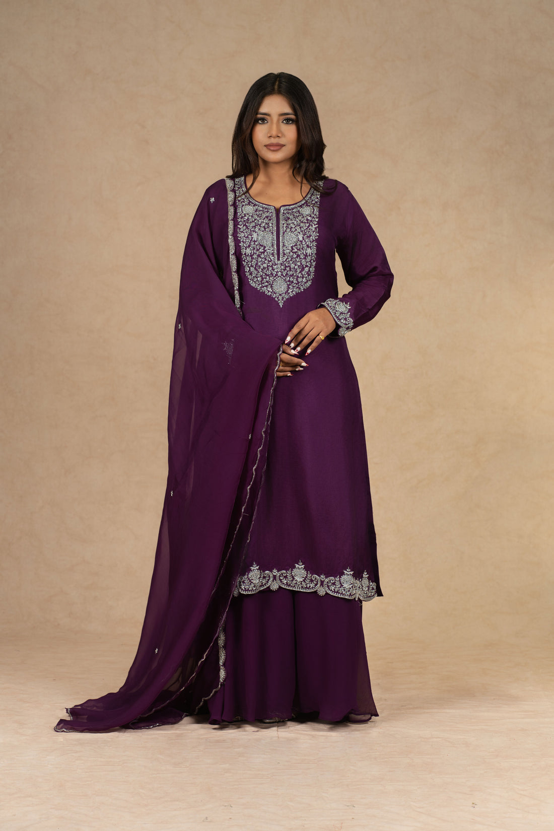 Elegant purple embroidered kurta set featuring intricate silver threadwork, paired with matching palazzo pants and a chiffon dupatta, perfect for festive and formal occasions.