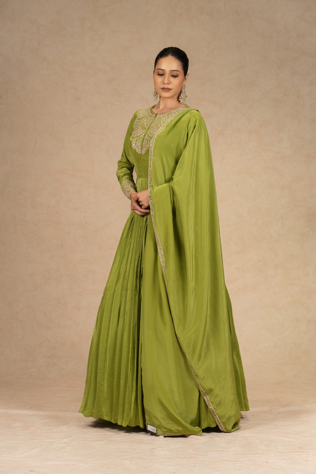 Lime green pleated Anarkali with dupatta, embellished with pearls, kasab, dabka, sequins, and pitai work, perfect for festive and wedding wear.