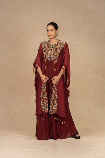 Maroon organza Indo-Western kurta set with intricate Dori, sequins, pearls, and thread embellishments, paired with matching flowy palazzo pants, perfect for festive and formal occasions.