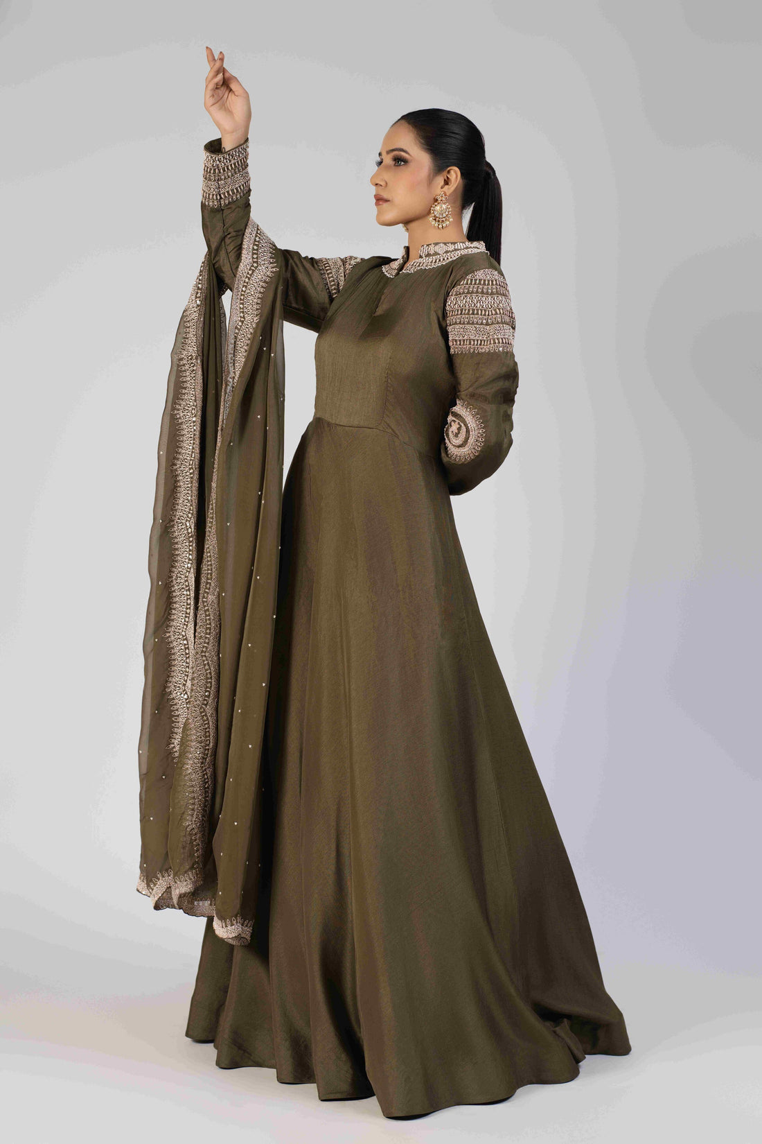 Mehndi Green Silk Gown with high neck embellishments, full sleeves, and an organza dupatta adorned with pearls, kasab, maal, and sequins, perfect for festive and formal occasions.