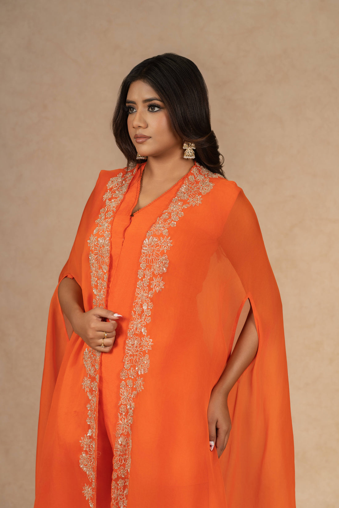 Orange Organza Indowestern short kurta and palazzo set with pearl and pitai embellishments, paired with a matching dupatta – perfect for festive and formal occasions.