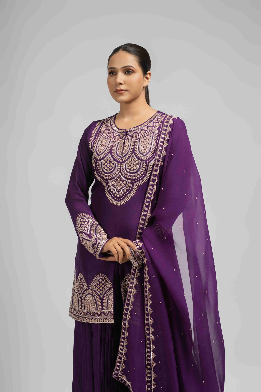 Purple embroidered silk sharara suit with organza dupatta, featuring intricate pearl, sequin, zardozi, kasab, and pitai work, ideal for festive and wedding wear.