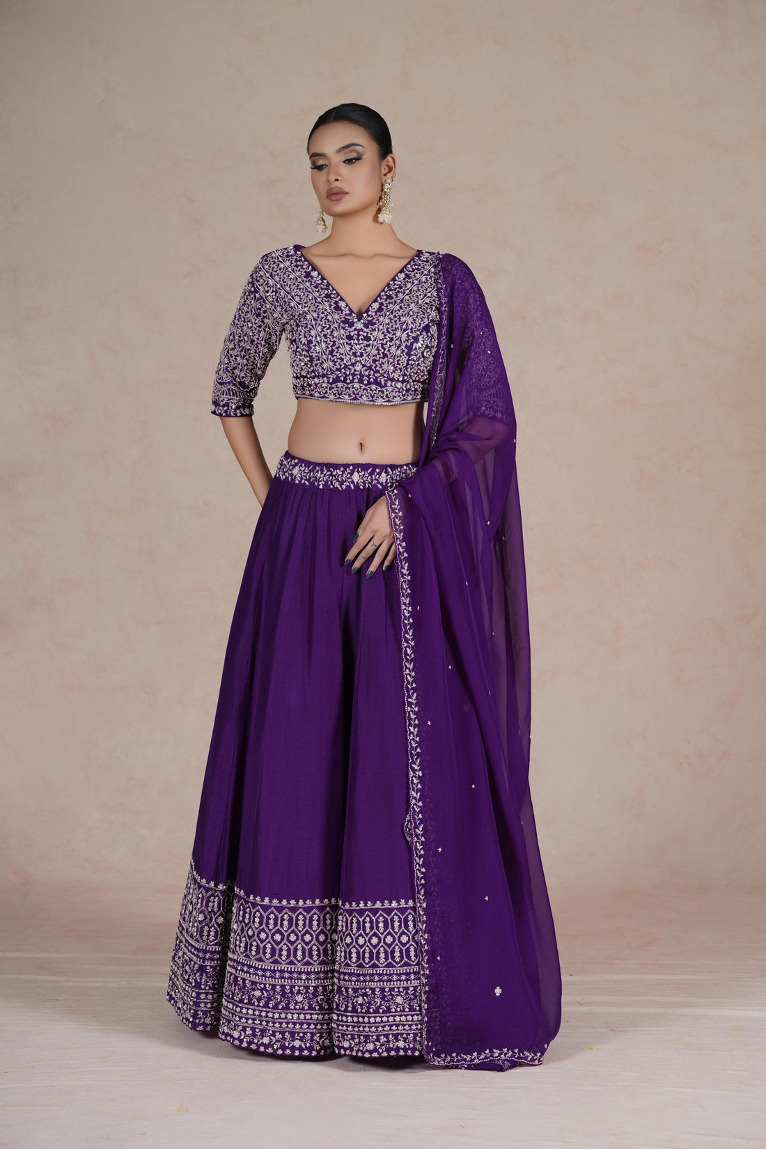 Purple embroidered lehenga choli set with intricate sequin, pearl, kasab, zardozi, and pitai work, paired with an organza dupatta – perfect for festive and wedding occasions.