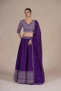 Purple embroidered lehenga choli set with intricate sequin, pearl, kasab, zardozi, and pitai work, paired with an organza dupatta – perfect for festive and wedding occasions.