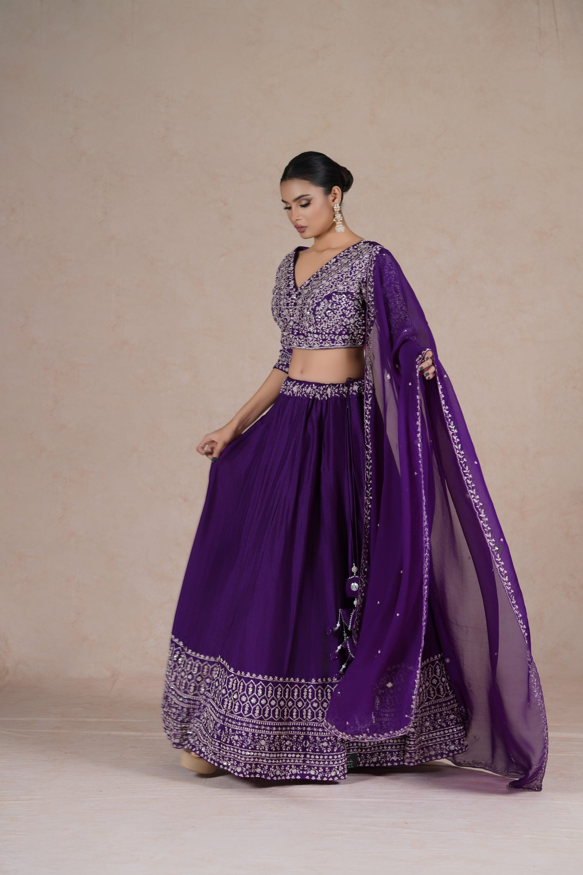 Purple embroidered lehenga choli set with intricate sequin, pearl, kasab, zardozi, and pitai work, paired with an organza dupatta – perfect for festive and wedding occasions.