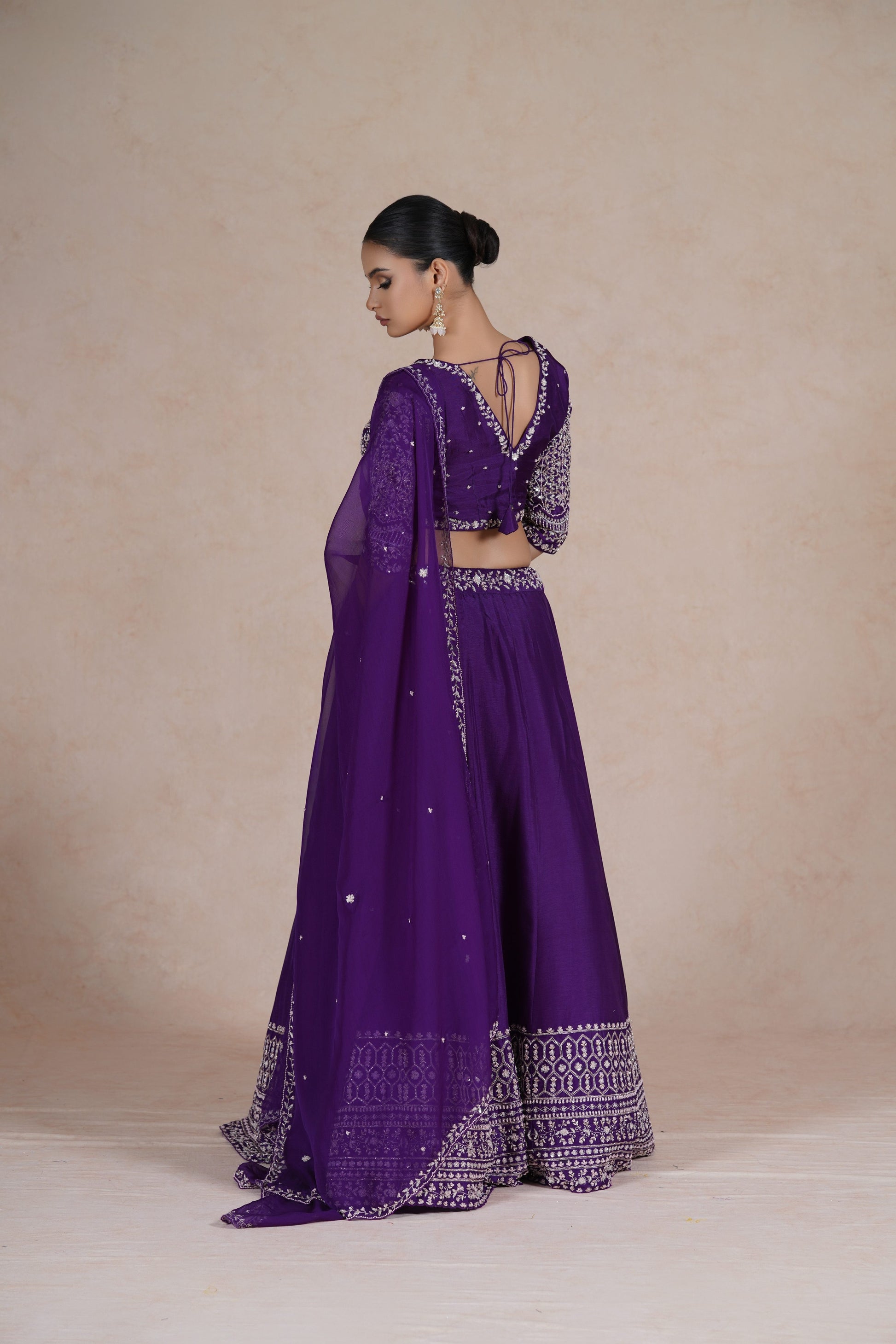 Purple embroidered lehenga choli set with intricate sequin, pearl, kasab, zardozi, and pitai work, paired with an organza dupatta – perfect for festive and wedding occasions.