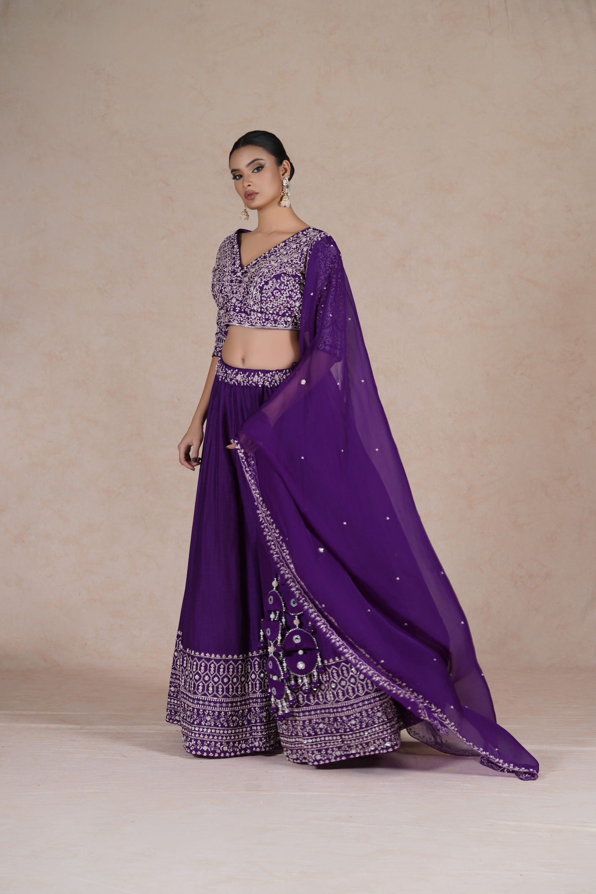 Purple embroidered lehenga choli set with intricate sequin, pearl, kasab, zardozi, and pitai work, paired with an organza dupatta – perfect for festive and wedding occasions.