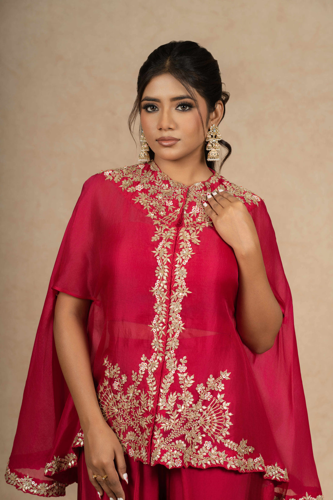 Rani Organza Indowestern outfit featuring a cape-style embroidered top with a bustier and dhoti pants, ideal for festive occasions and formal wear.
