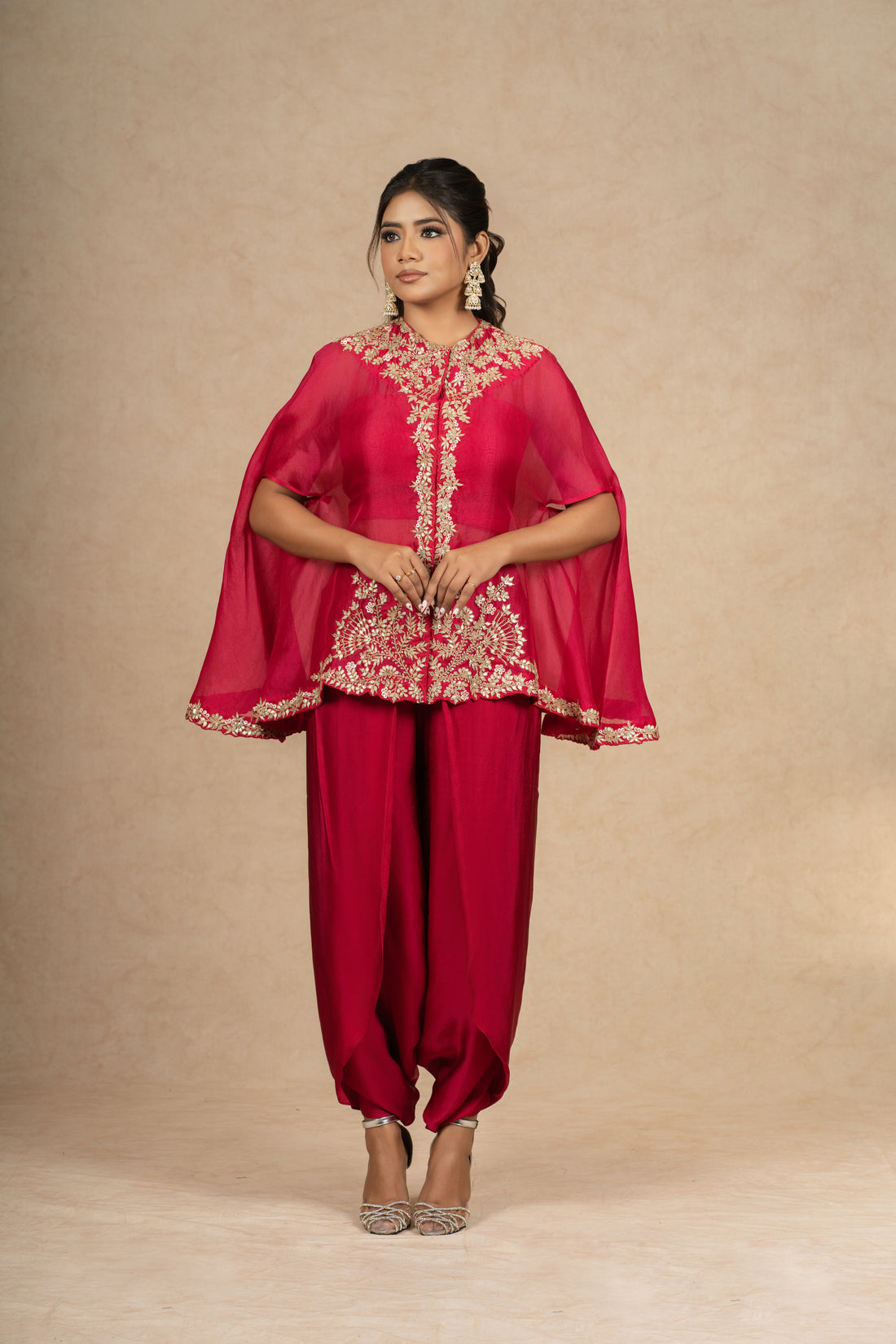 Rani Organza Indowestern outfit featuring a cape-style embroidered top with a bustier and dhoti pants, ideal for festive occasions and formal wear.
