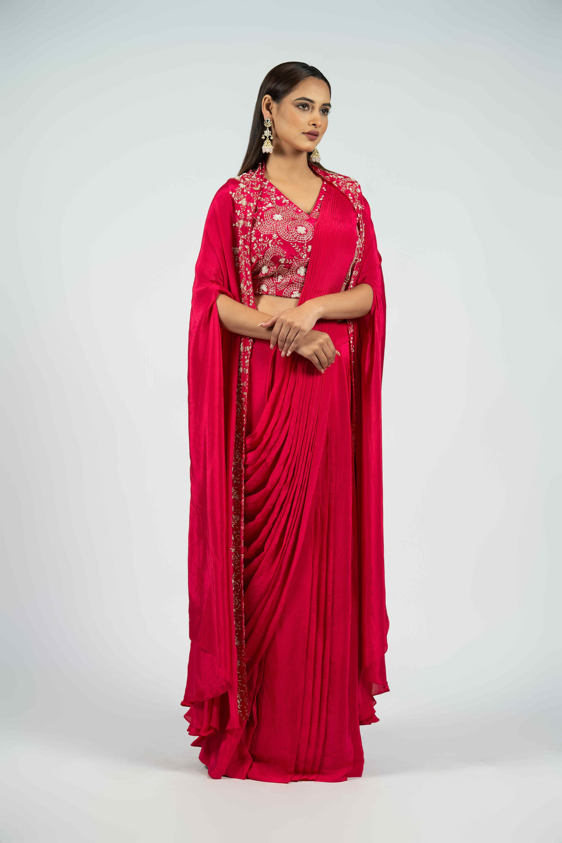 Raspberry crepe ready-to-wear drape saree with an embellished cape, featuring intricate pearl, kasab, sequins, and pitai work for a sophisticated festive look.