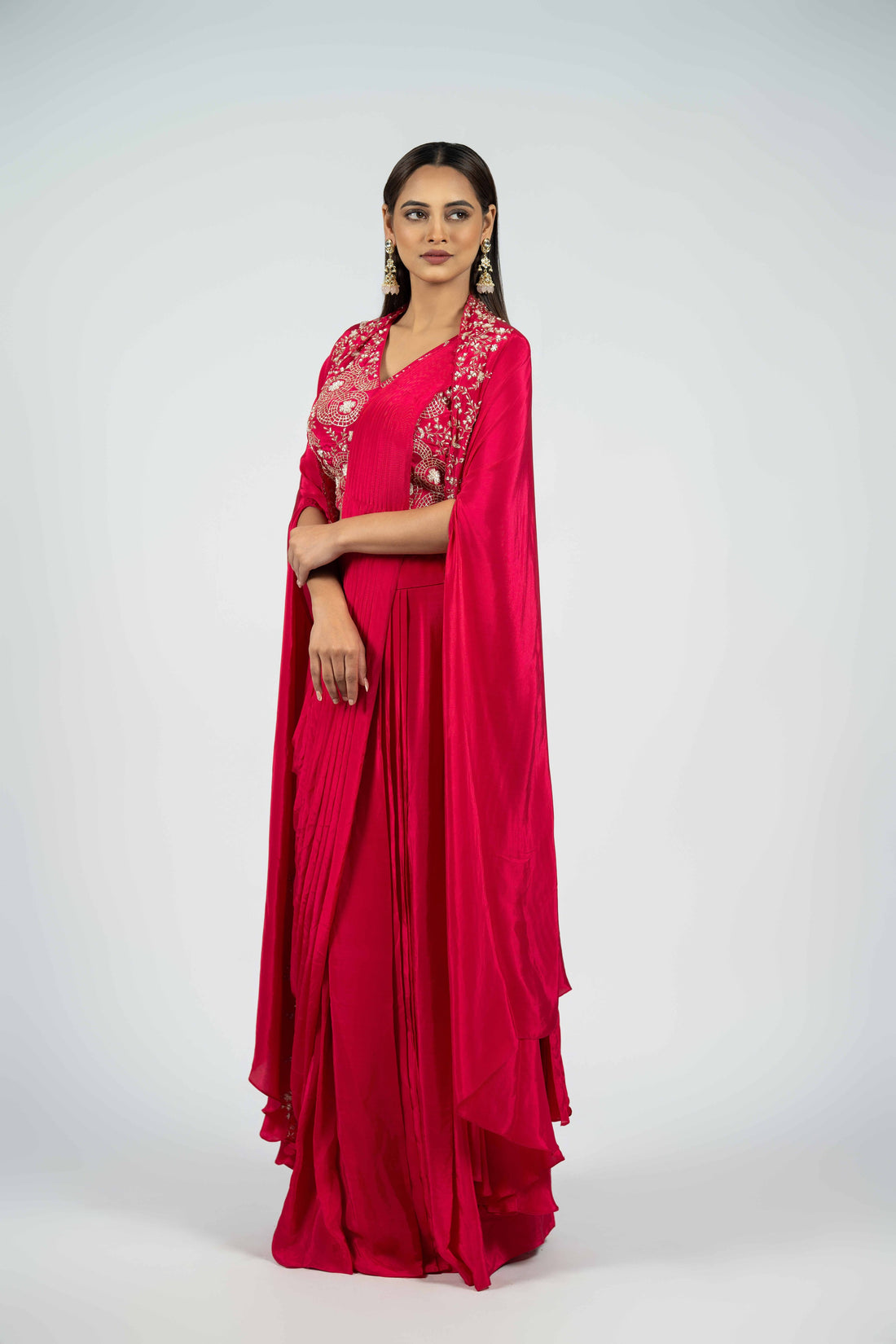 Raspberry crepe ready-to-wear drape saree with an embellished cape, featuring intricate pearl, kasab, sequins, and pitai work for a sophisticated festive look.