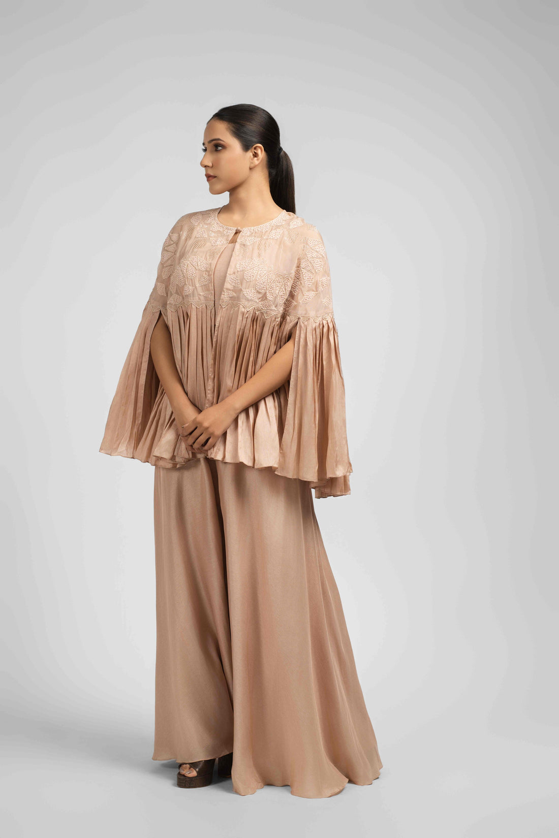 Elegant Ash Rose Pink Indo Western Set featuring a pleated jacket, sleeveless crop top, and flared palazzo.
