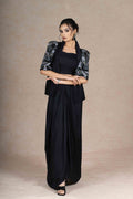 Black and gray embroidered jacket with cape sleeves, sweetheart neckline bustier, and pre-draped silk skirt. Elegant and lightweight festive wear.