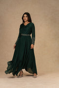 A model wearing a Bottle Green Chinnon Gown with an Ivory Organza Indowestern drape skirt and a bustier, adorned with dori work and pearl embellishments, styled for festive or formal occasions.