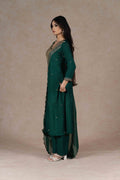 A-line green kurta with a straight hem, paired with embroidered pants, highlighting the flowy silhouette and breathable fabric.