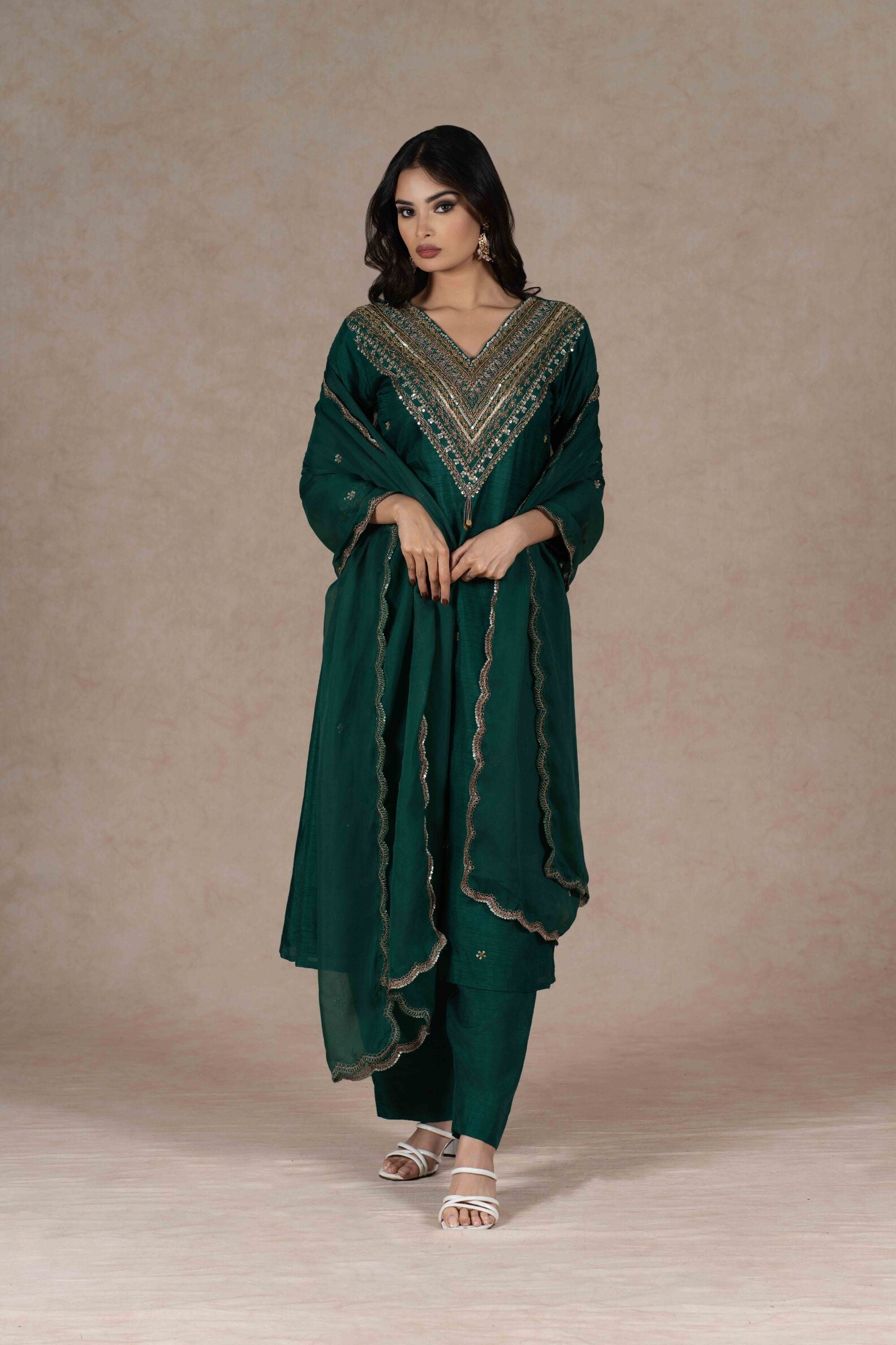 Model wearing the embroidered green kurta set, accessorized for a puja or festive occasion, blending tradition with modern style.