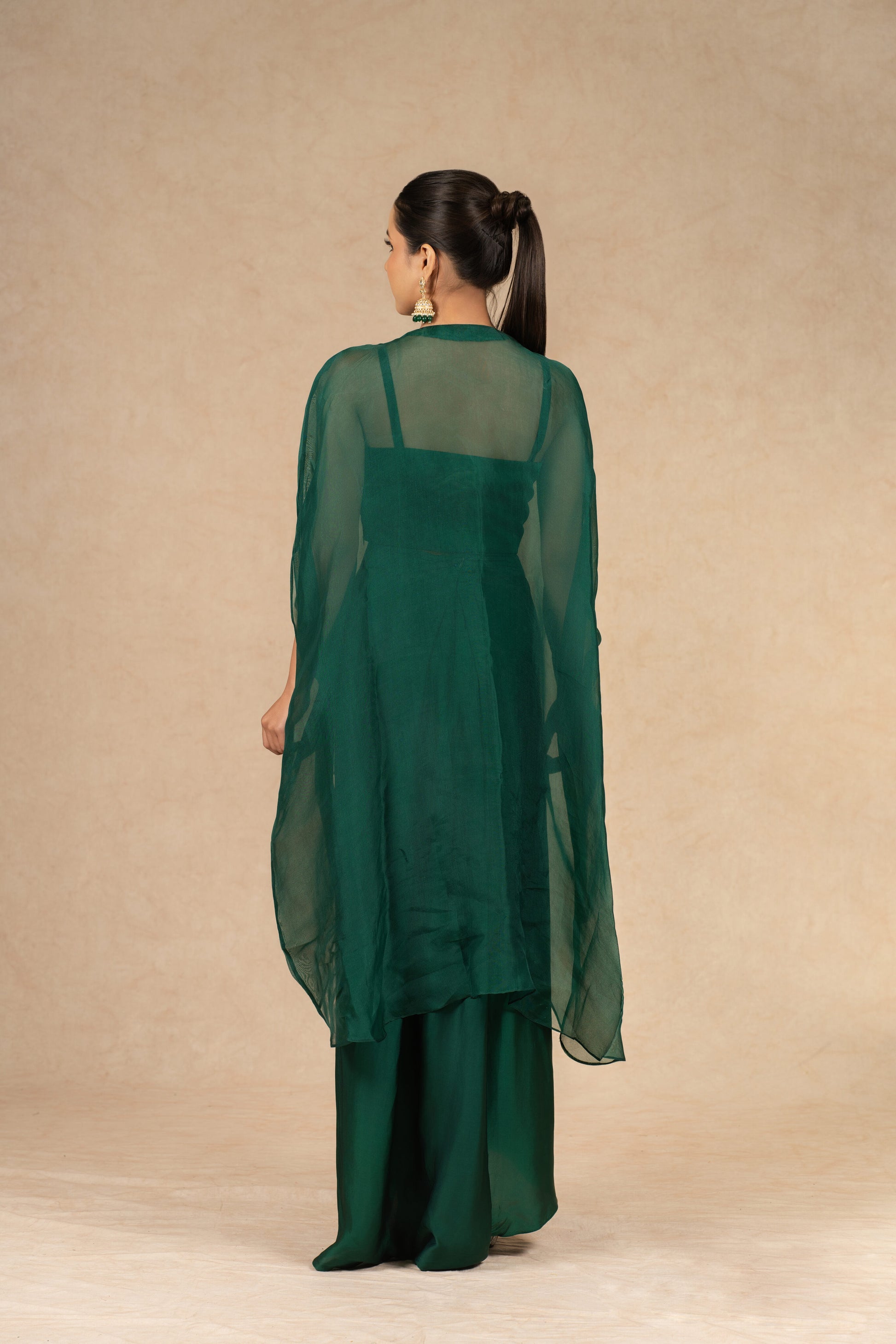 Rear view of the Bottle Green Organza Indowestern, showcasing the sheer cape overlay and fitted bustier from the back.