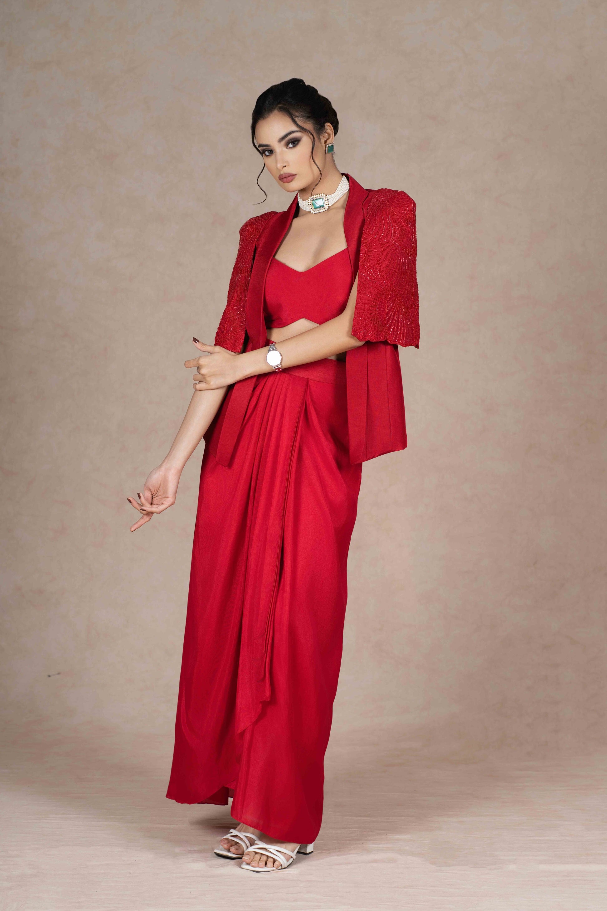 Cherry red jacket, bustier, and pre-draped skirt with hand-beaded cape sleeves. Lightweight, stylish, and perfect for festive, wedding, or formal occasions.