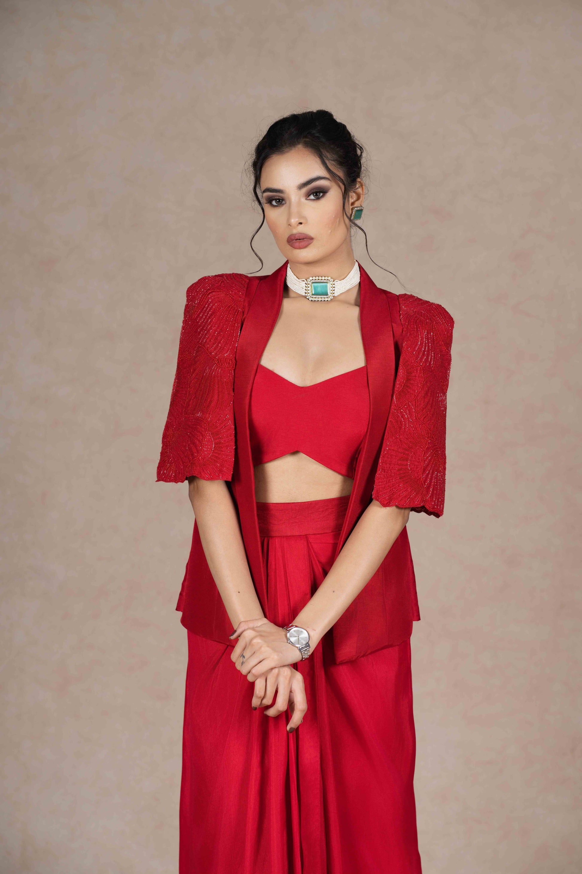 Cherry red jacket, bustier, and pre-draped skirt with hand-beaded cape sleeves. Lightweight, stylish, and perfect for festive, wedding, or formal occasions.