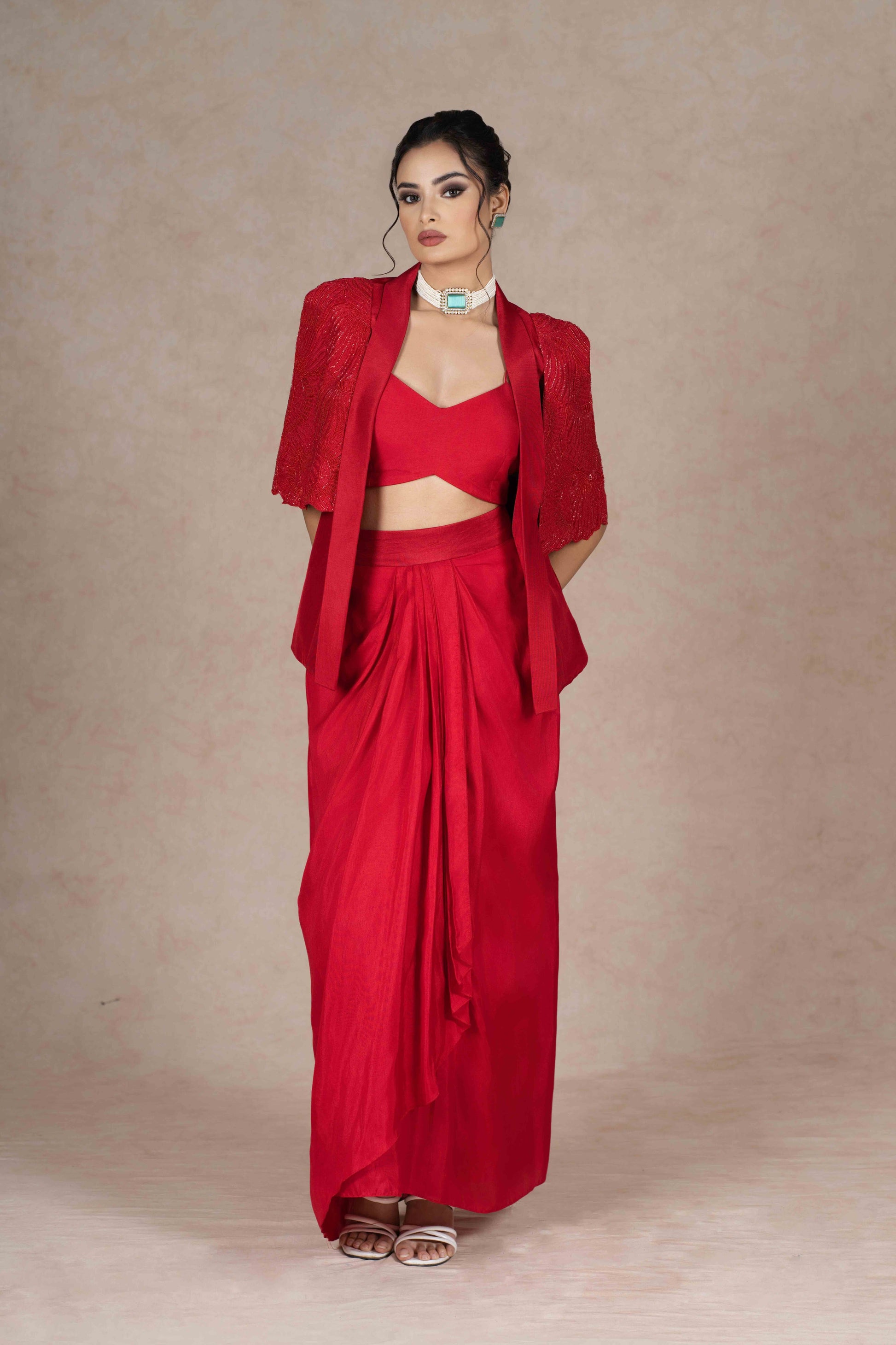 Cherry red jacket, bustier, and pre-draped skirt with hand-beaded cape sleeves. Lightweight, stylish, and perfect for festive, wedding, or formal occasions.