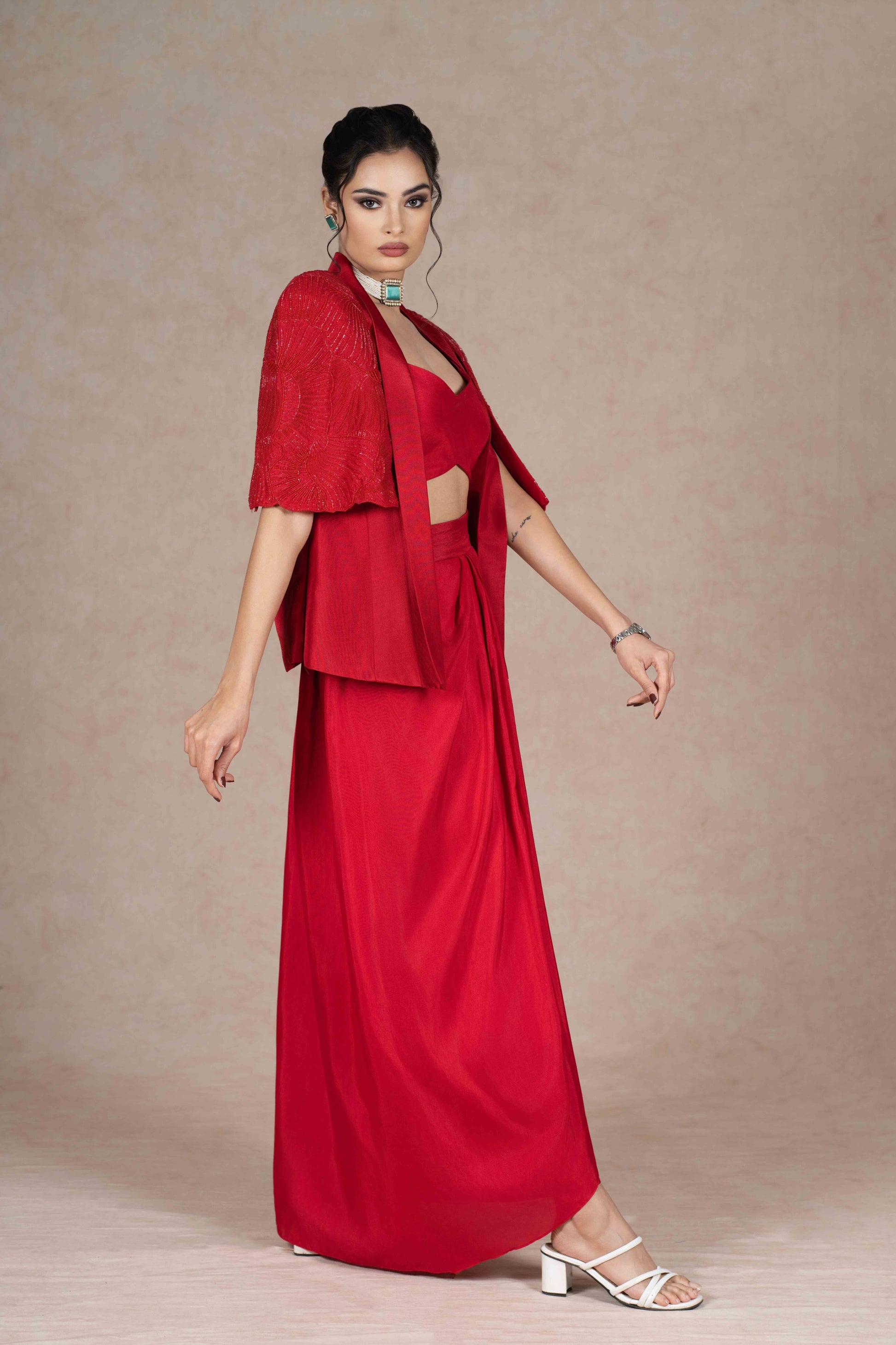 Cherry red jacket, bustier, and pre-draped skirt with hand-beaded cape sleeves. Lightweight, stylish, and perfect for festive, wedding, or formal occasions.