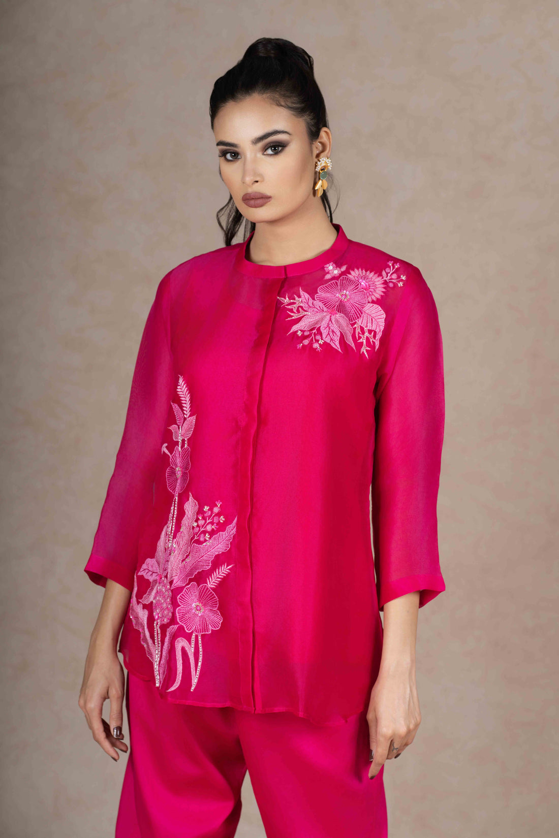 Model wearing a Fuchsia Organza Co-ord Set with floral embroidery, featuring a front-open top with three-quarter sleeves and matching trousers.