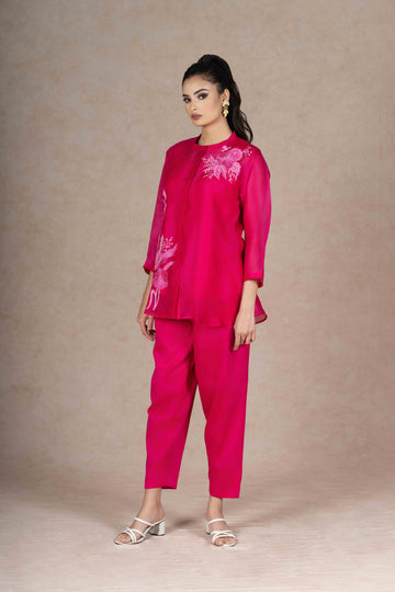 Model wearing a Fuchsia Organza Co-ord Set with floral embroidery, featuring a front-open top with three-quarter sleeves and matching trousers.