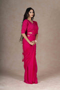 Fuchsia ready-to-wear drape saree with embellished blouse and tie-up belt, crafted in lightweight crepe fabric for a stylish and comfortable festive look.