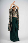 Green crepe crop top with cape sleeves and matching drape skirt embellished with kasab, sequins, thread, and cutdana embroidery – Indo-western festive outfit.