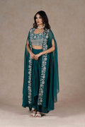 Emerald green three-piece set with an embroidered bustier, a sheer cape with zardozi embroidery, and a draped skirt. A perfect blend of elegance and modern style.