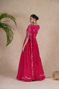 A hot pink embroidered gown with drape, featuring pearl, kasab, zardozi, sequins, and pitai work. Perfect for festive occasions and formal events.