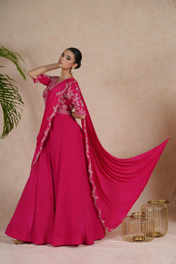 A hot pink embroidered gown with drape, featuring pearl, kasab, zardozi, sequins, and pitai work. Perfect for festive occasions and formal events.