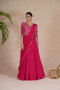 A hot pink embroidered gown with drape, featuring pearl, kasab, zardozi, sequins, and pitai work. Perfect for festive occasions and formal events.