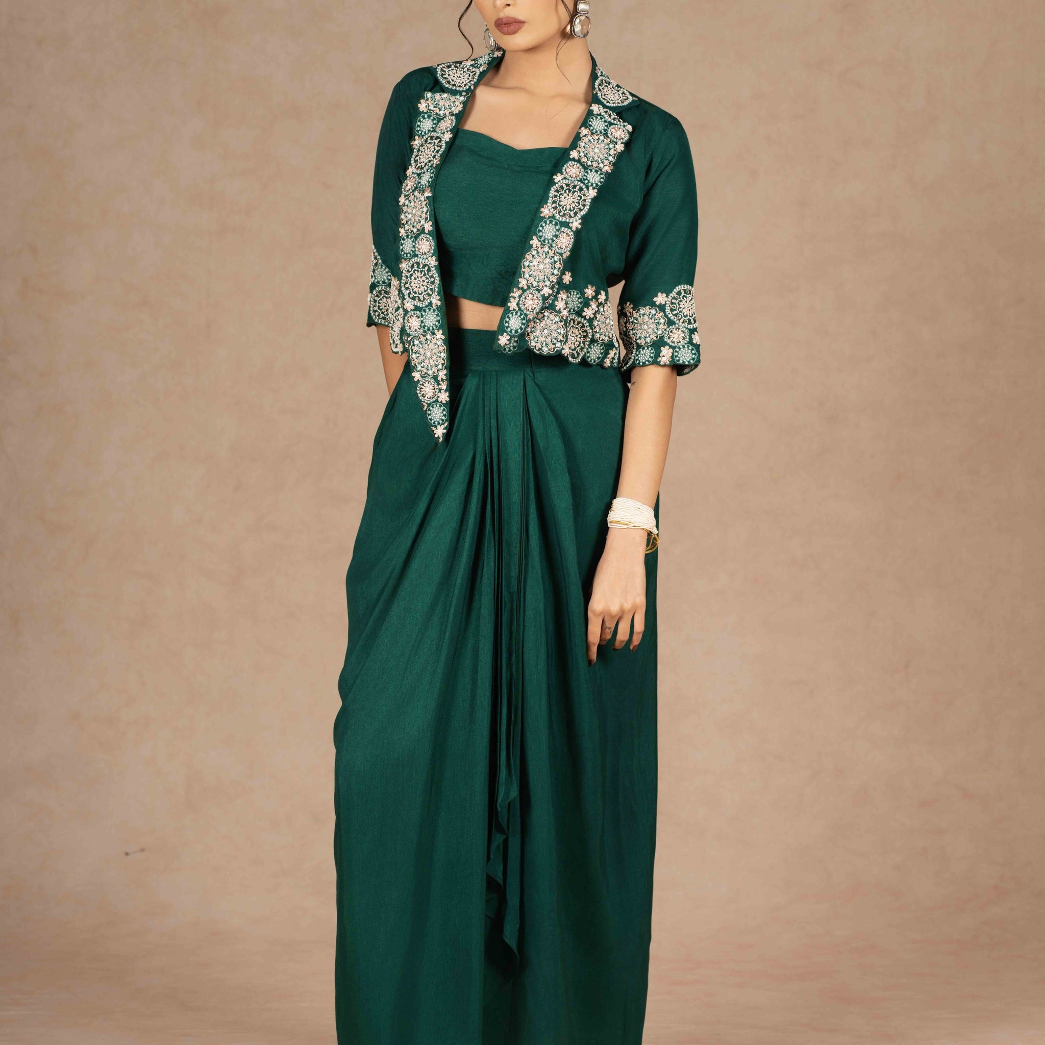 Elegant emerald green Indo-western with embroidered jacket and drape skirt perfect for any festive or formal occasion.