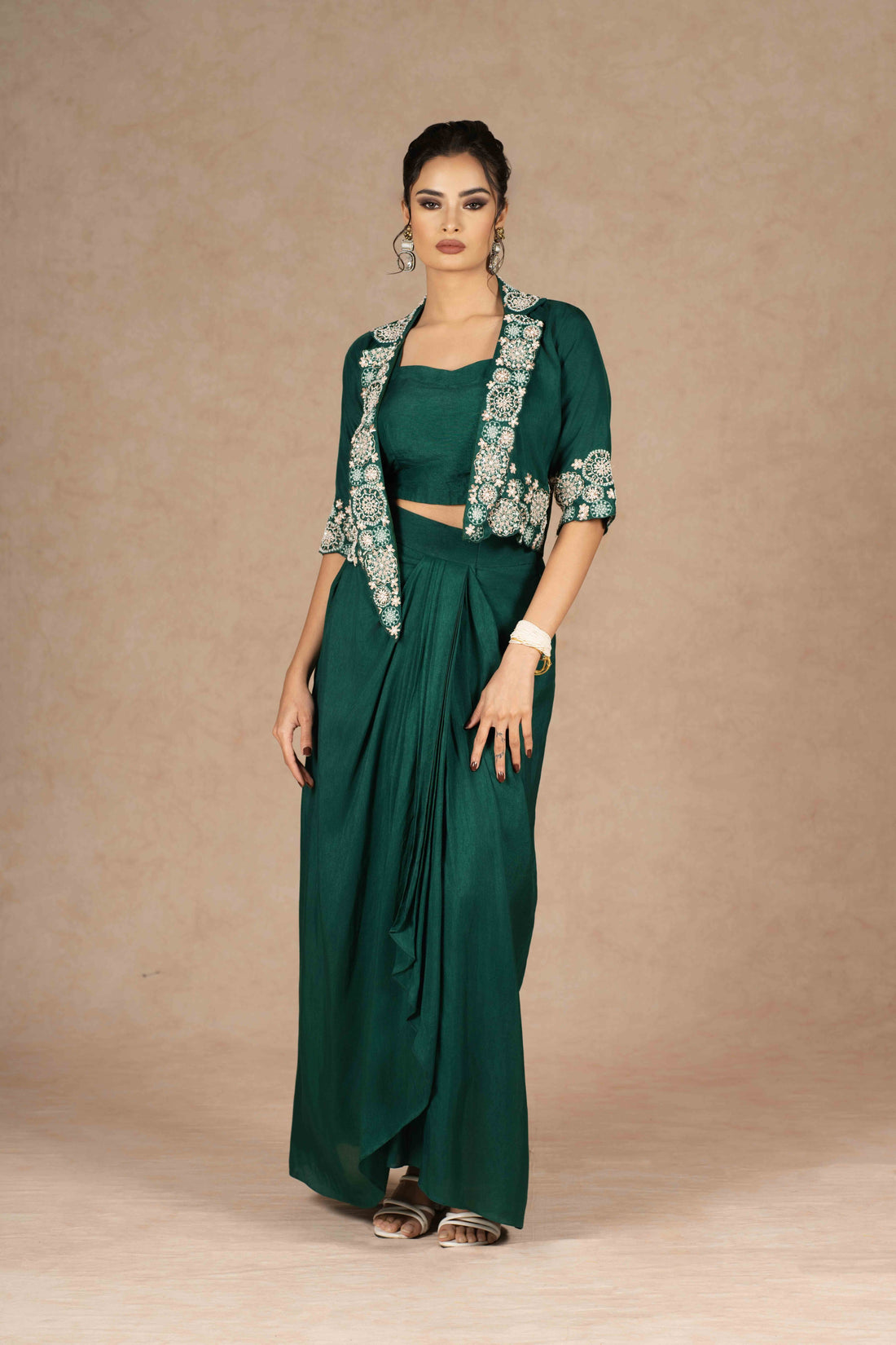 Elegant emerald green Indo-western with embroidered jacket and drape skirt perfect for any festive or formal occasion.