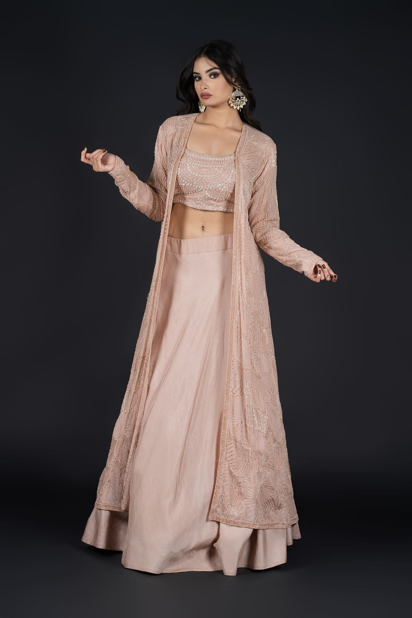 Model gracefully posing in an elegant Indo-Western Skirt with a long embroidered jacket, perfect for any occasion.