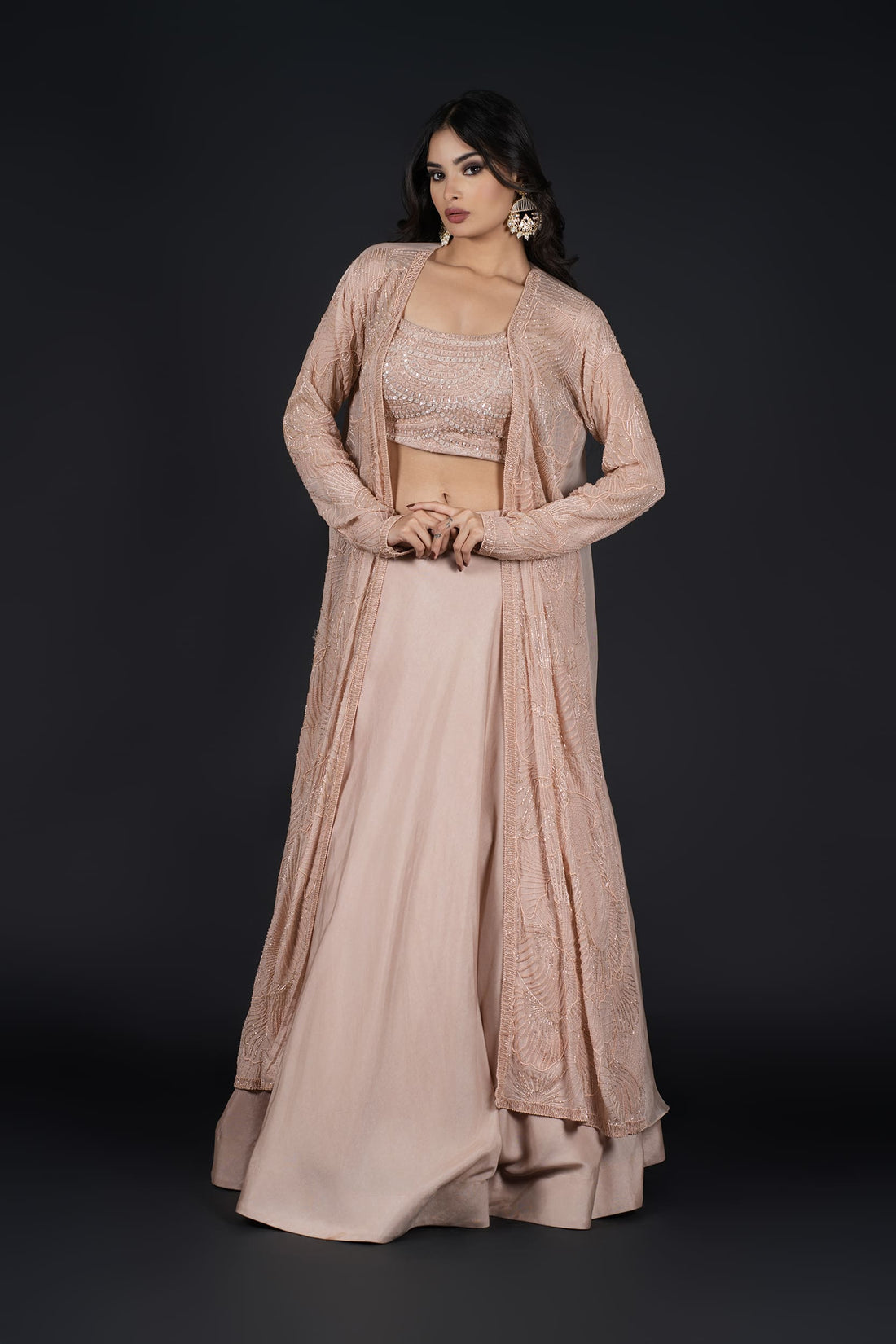 Model gracefully posing in an elegant Indo-Western Skirt with a long embroidered jacket, perfect for any occasion.