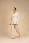 Full-length view of the Ivory Silk Blazer set, featuring a structured blazer with artistic embroidery and matching wide-leg pants.