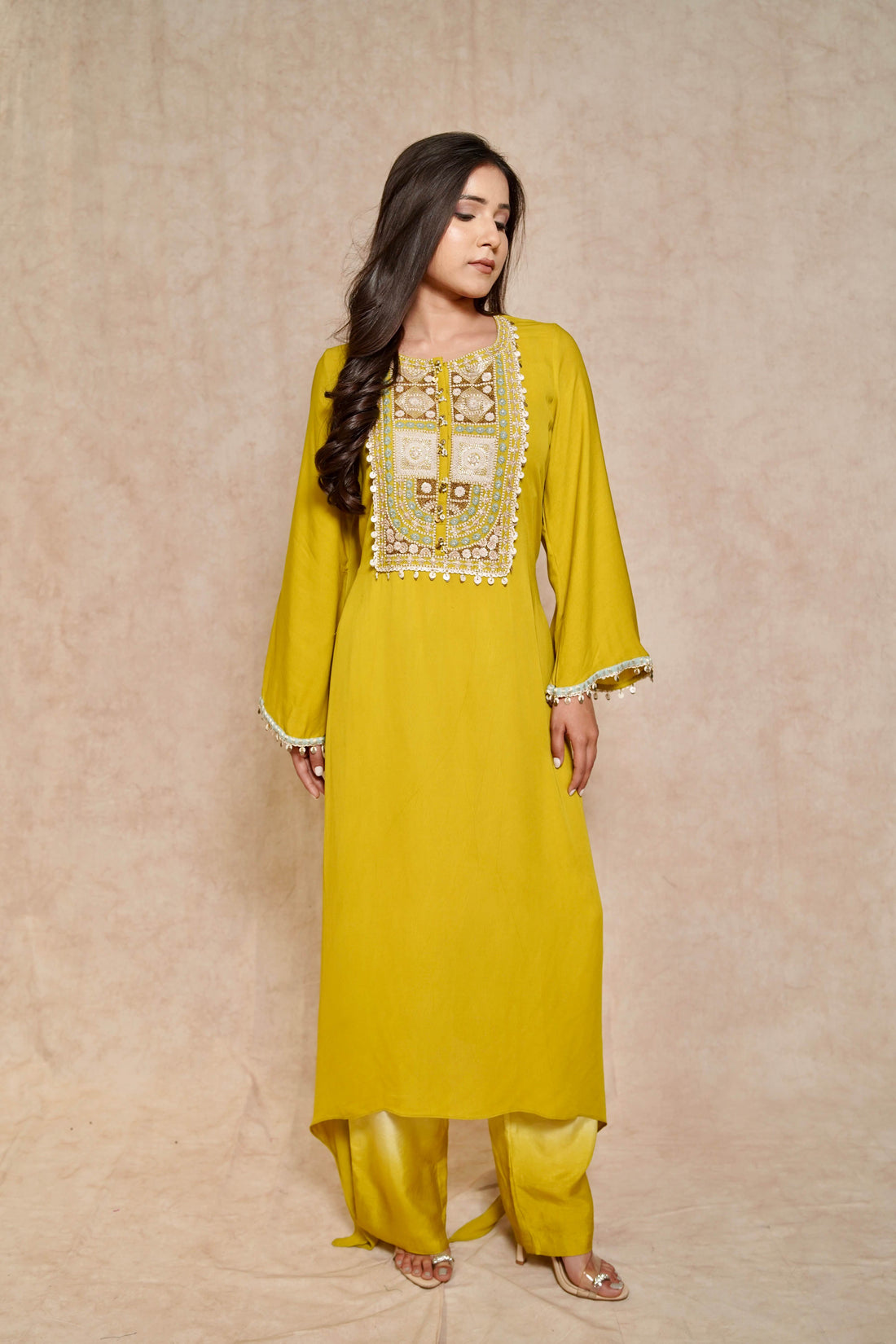 Model wearing a lime green kurta set for women, featuring intricate embroidery and bell sleeves – a perfect festive kurta and palazzo set.