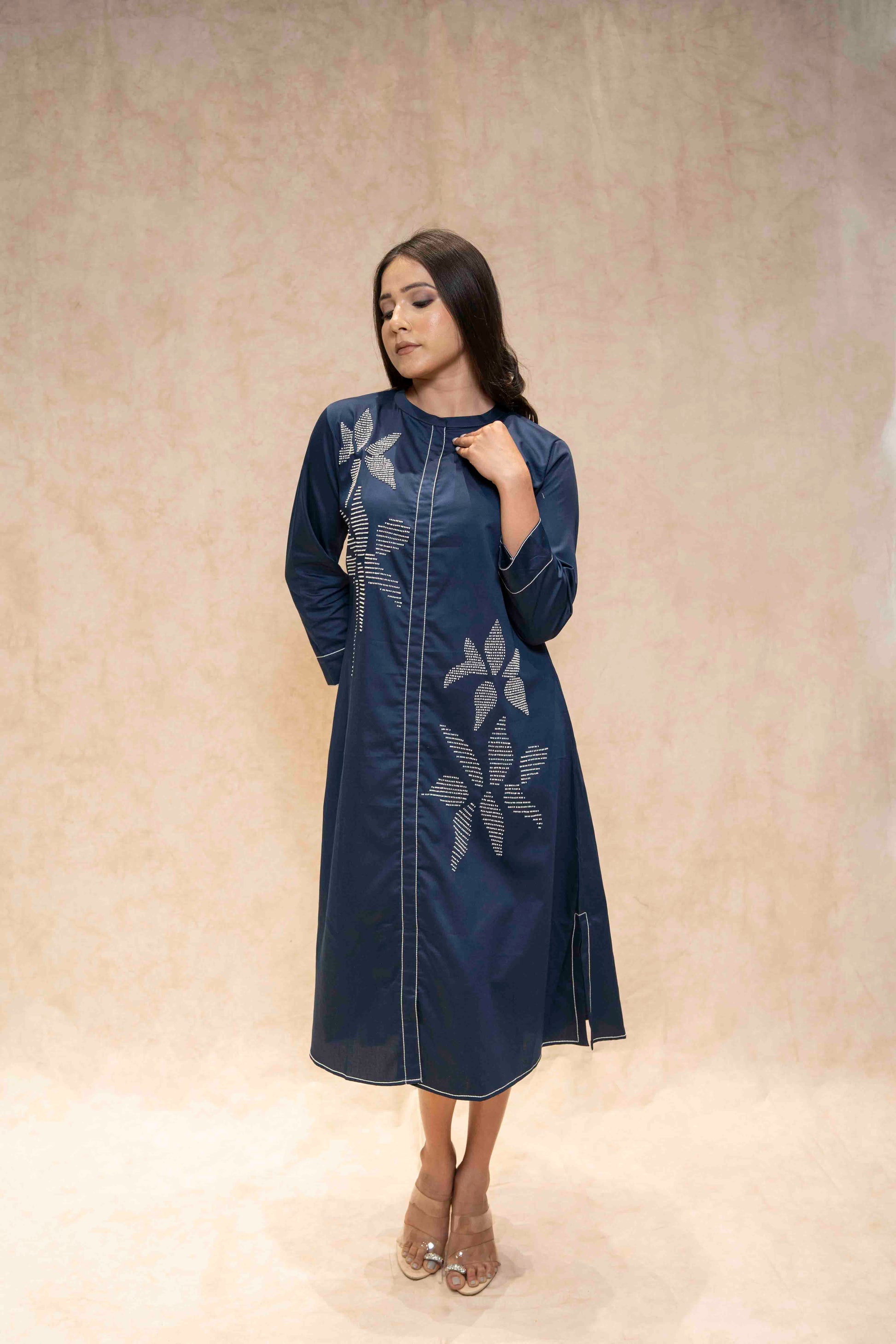 Closeup of floral embroidery on navy blue kurta