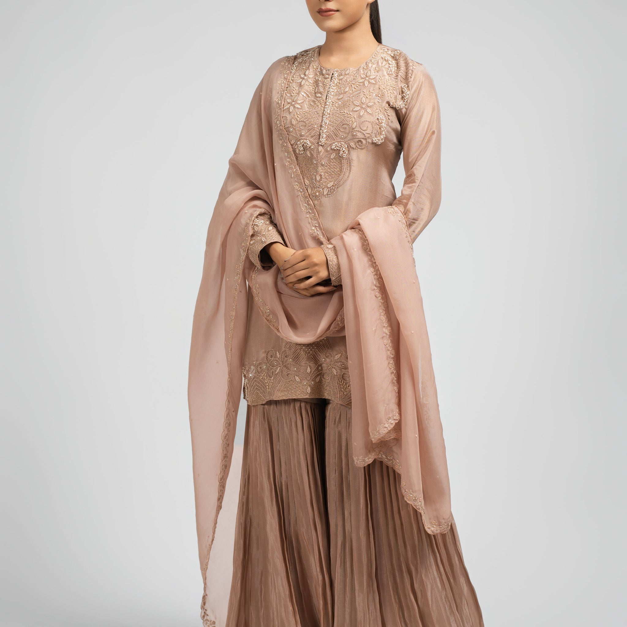 Elegant Pink Sharara Suit adorned with zardozi, pearls, and sequins, paired with an organza dupatta.