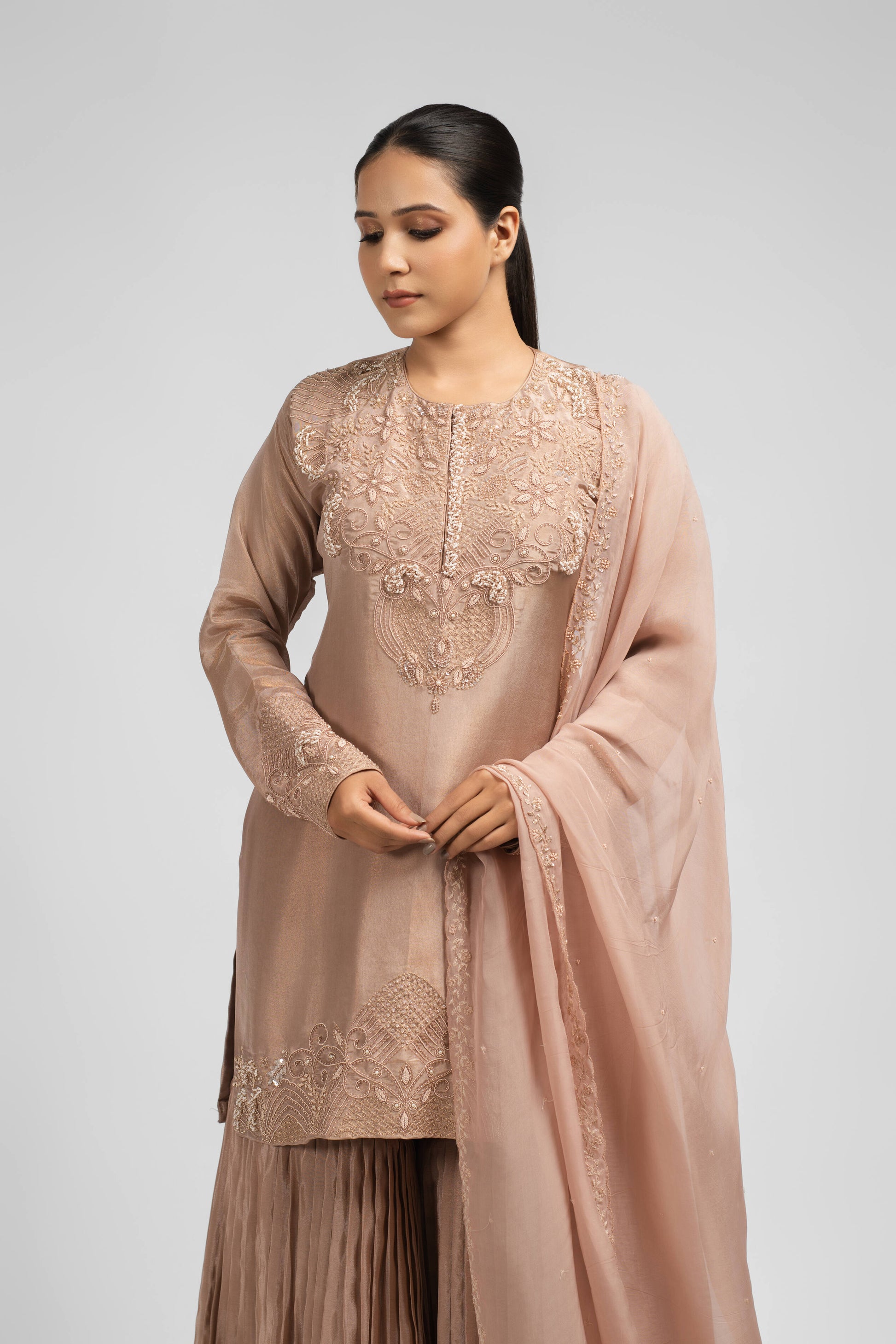 Traditional Pink Sharara Suit featuring exquisite craftsmanship and intricate embroidery.