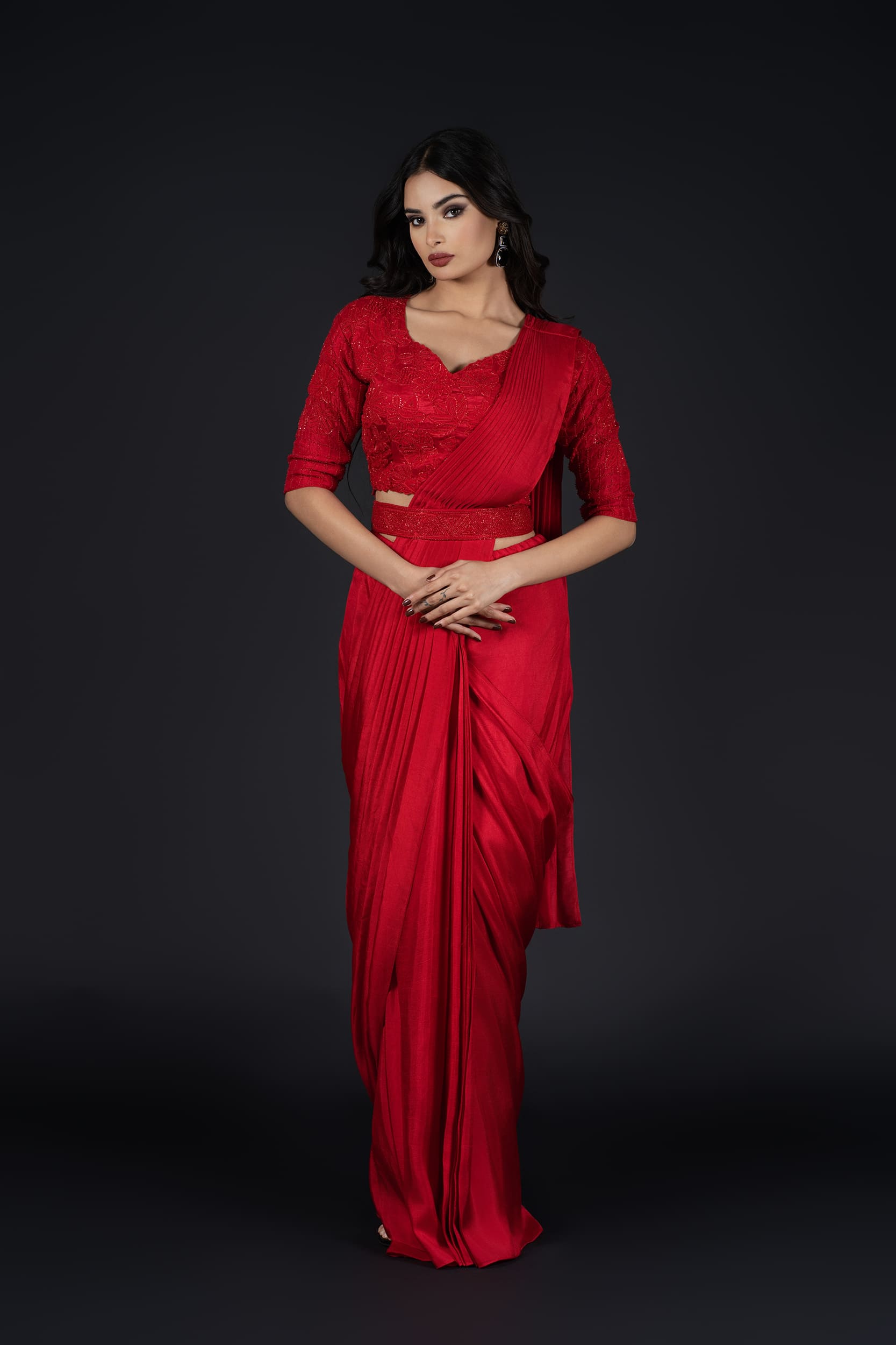 Detailed shot of the pre-pleated red saree, offering effortless sophistication and a modern twist.