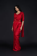 Red pre-draped saree with sleek pleats and flowy silk fabric, combining modern convenience with elegance.