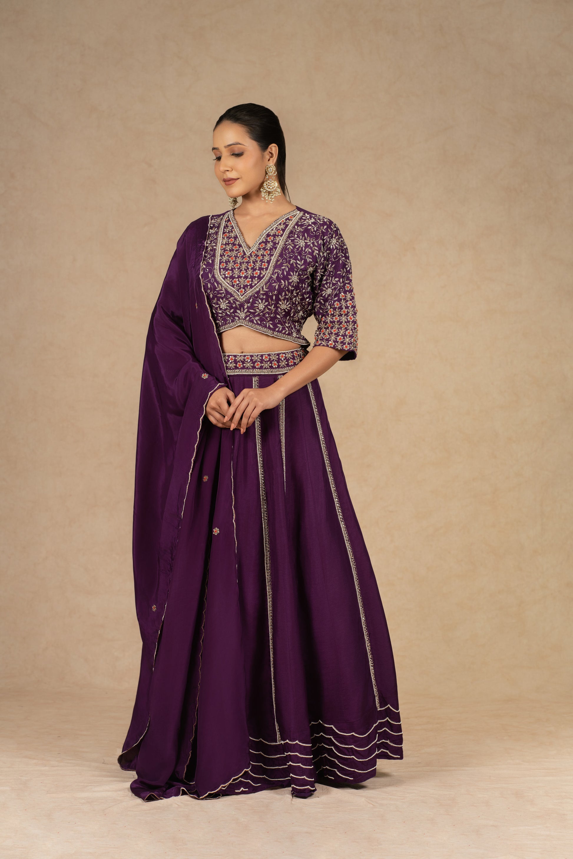 Purple silk kalidar lehenga choli with dupatta featuring intricate dabka, sequins, thread, and pearl embellishments, ideal for festive and wedding occasions.